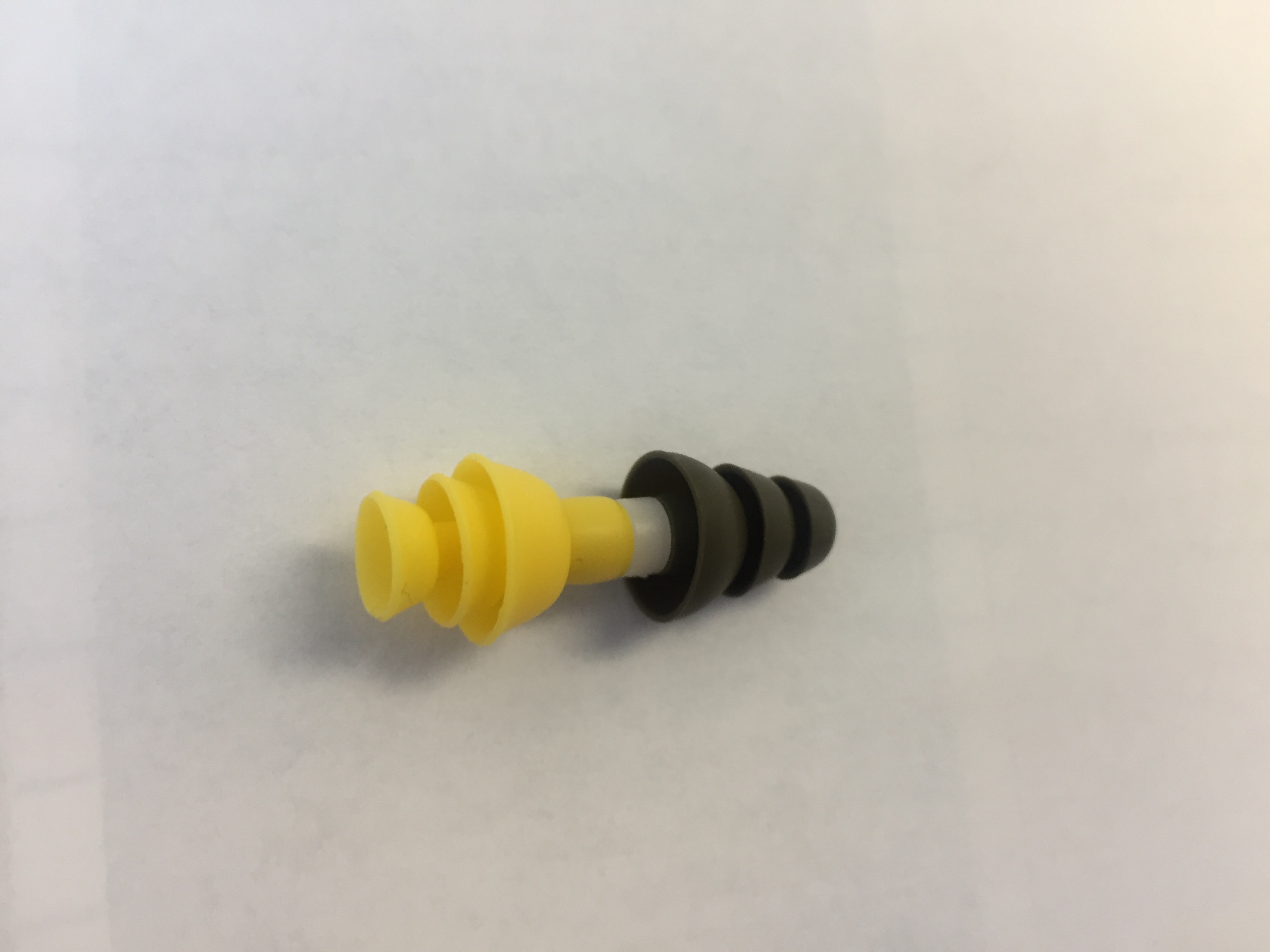 defective 3M military earplug with yellow flanges folded back
